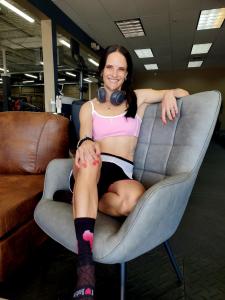 Mari Myers, owner of Littleton Fitness, sitting in the lounge area a the gym