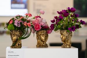 Althea Wiles' 2025 Art in Bloom installation "The Flowers Personified" features floral arrangements inspired by J.J. Grandville's anthropomorphized botanical illustrations. Photo credit: Tommy McFetridge, Courtesy of Crystal Bridges.