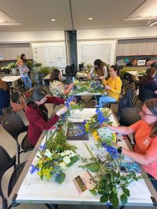 Althea Wiles teaches participants in her "Floral Design FUNdamentals" workshop during Art in Bloom weekend, where attendees created arrangements inspired by Clara Driscoll's Wisteria Table Lamp. Photo courtesy of ©AltheaWiles.