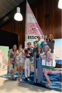 Young Professionals Committee (L-R) Skylar Borucke, Lindsay Berman with puppy Mateo, Sklyer Moran with dog Static, Daniel Spelman, Alyssa Moudis, Kimberly Dautenhahn, top row, Meghan Bozek, Elizabeth Mellgard Nelson, Hana Betts (Photo Credit: Andrew Werne
