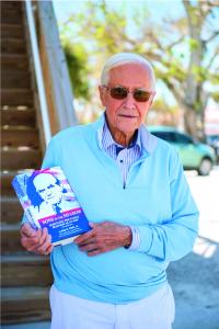 Son of the Boss, Roy H. Park, Jr., stands proudly with a hard bound version of his newly released book Sons in the Shadow, Surviving the Family Business as an SOB* (Son of the Boss)