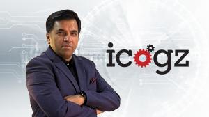 Portrait of Amit Tripathi, Founder and CEO of icogz, standing in front of the icogz logo with a futuristic AI background.