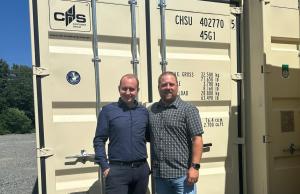 Christian Leopold, Managing Director of CHS Container Group, and Bill Franzke, General Manager of CHS Container Group USA, stand in front of a shipping container in Monroe, NC