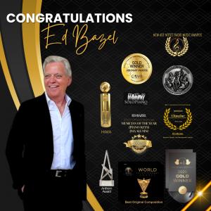 Tall gentleman in suit against black backdrop showing myriad awards trophies and laurels
