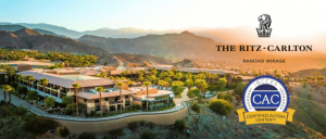 Aerial view of The Ritz-Carlton, Rancho Mirage, showcasing its luxurious property amidst mountains and palm trees, with certification badge.