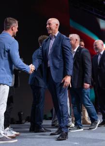 Gary Salman, Black Talon CEO, shakes hands with Lane Brannan, Pax8 Executive Vice President & General Manager of Americas, on stage at the Pax8 2025 Beyond Conference