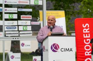 John Graham, President of CIMA Global, speaking at a podium during the launch of the CIMA Mayor’s Trophy Cricket event.
