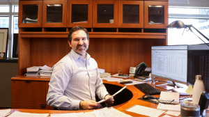 Ryan Fleischer, Founder of Revolution Group, seated at his desk in Omaha, Nebraska office.