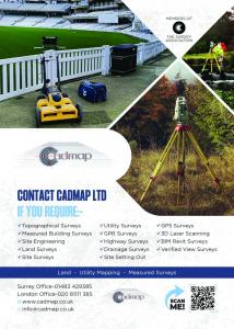 Surveyor using total station for topographical land measurement in the UK