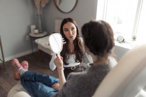 Patient receiving a full face aesthetic consultation at Cheeky Denver