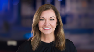 Angela Rogers, Co-Owner of Cheer Athletics, smiling in professional portrait after being named Team Manager for the Varsity Pro Cheer League.