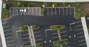 Photo of parking lot being sealed with soy-based RePlay.