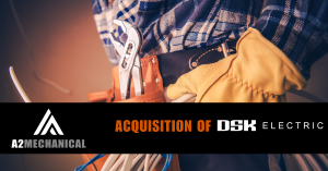 A2 Mechanical Group acquisition announcement graphic showing a tradesperson’s toolbelt with pliers, electrical wiring, and gloved hands, alongside the text "Acquisition of DSK Electric" and A2 Mechanical logo.