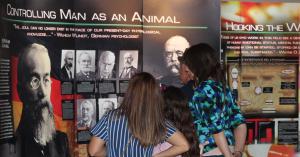 Visitors study one of the displays at the Psychiatry: An Industry of Death Exhibit in Old Sacramento