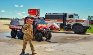 Scott Air Force Base's Fire Chief Shanton Russell gives a thumbs up to Team Wildfire's fire tech.