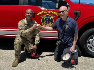 Chief Shanton Russell and Steve Wolf celebrate a successful demonstration at Scott Air Force Base