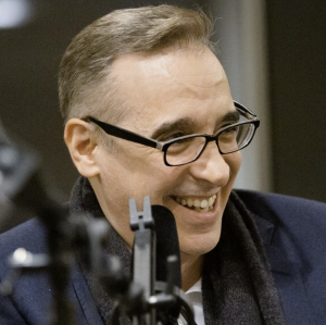 Podcast Host Frank Santopadre at the microphone, in conversation with a guest.