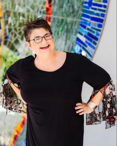 Jennifer Stancil stands on balcony