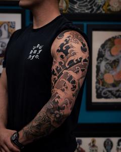 Traditional Japanese tattoo featuring waves - half sleeve by Tyler Ciarlanti