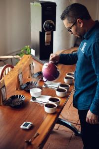 Spirit Animal Coffee team cupping and evaluating Cup of Excellence-winning coffee.          Ask ChatGPT