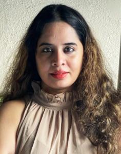 Rochelle Potkar, author of "The D’Costa Family" smiling straight into the camera.