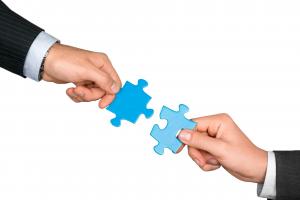 Puzzle pieces symbolizing the 1836PM-WHPM partnership