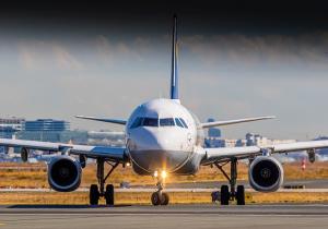 Commercial airplane parked at an airport gate representing aviation professionals who benefit from Asana Recovery’s outpatient rehab for pilots and airport workers.