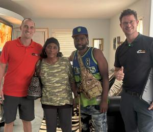Bernice T. standing with Rock Pest Control team after winning free bed bug extermination in Kansas City.  Let me know if you want a second version optimized for social or thumbnail use.