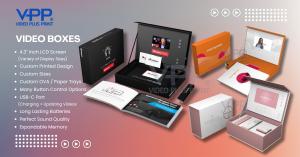 "Person opening a custom-designed Video Box with high-quality printed packaging and an embedded LCD screen playing a branded video. The image showcases the premium unboxing experience, foam insert for product display, and interactive video feature that en