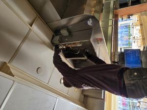 A done right hood and fire safety technician installing a fire suppression system.