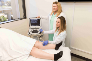 Female doctors look at leg vein ultrasound