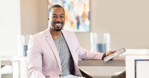 Photo of DeAngelo Burse, psychology professor, TEDx speaker, and author of Yours To Design, smiling confidently in a professional setting.