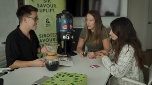 Three coworkers enjoying an &BACK COFFEE tasting in an office.