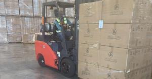 fork lift in warehouse with a pallet of air purifiers