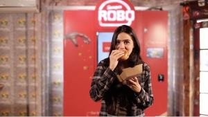 A customer enjoys a freshly made RoboBurger.