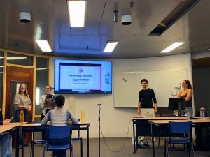 The fouders of Termzy AI are standing in front of the beamer at the launch presentation at University of Amsterdam