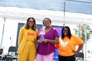Congresswoman Sydney Kamlager-Dove, Changemaker Honoree Macy Gray, and White Hall Arts Academy Founder Tanisha Hall on stage at Rock The Block LA 2023