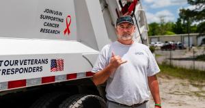 Ryan Mellichamp, owner of Sandlapper Waste, standing in front of branded garbage truck, showcasing locally owned and operated waste management service in South Carolina.