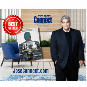 man is a suit with office background displaying book in spenish as a best seller