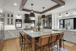 Award-winning kitchen featuring transitional cabinetry in walnut and black paint