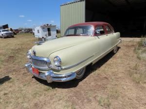 1951 maroon and cream Nash Ambassador custom 4dr sedan. Wide white walls. 6 cylinder, A/T. Original paint and interior. Does not run. The odometer shows a minuscule 9,269 miles.