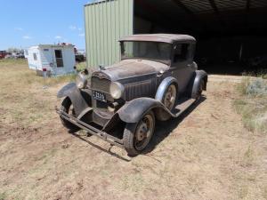 1930 grey and black Ford Model A coupe. Original. Side mount spare. Wire spoked rims. No seat in rumble seat. 4 cylinder gas. Manual transmission. 47,533 miles. Cloth bench. Heater.