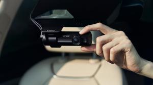 BlackVue DR970X Plus II Installed in Vehicle with Hand holding it
