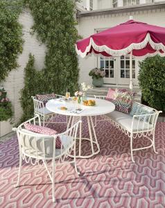 Ballard Designs summer outdoor umbrella and patio furniture scene
