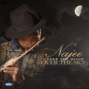 Najee blowing into a flute wearing a black hat as half the moon peaks from the upper right corner of the picture.