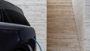 JLR electric vehicle, stationary with charger plugged in