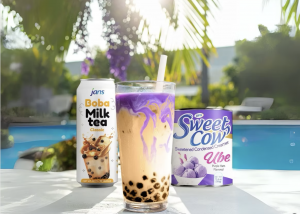 Sweet Cow Ube condensed milk poured into a purple boba drink, held by the pool, reflecting a fun, summery twist on the trending ube milk craze.