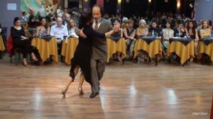 Chan Park performing tango at Milonga El Beso in Buenos Aires, surrounded by an attentive audience during a night of recognition.