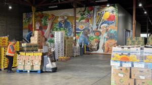Picture of Food Forwards warehouse and vibrant mural conveying its mission of providing fresh produce to those in need.