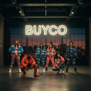 Runway scene at Buyco’s exclusive Winter ’25 press event, with models showcasing the brand’s trend-driven Y2K-inspired winterwear under a glowing BUYCO logo.